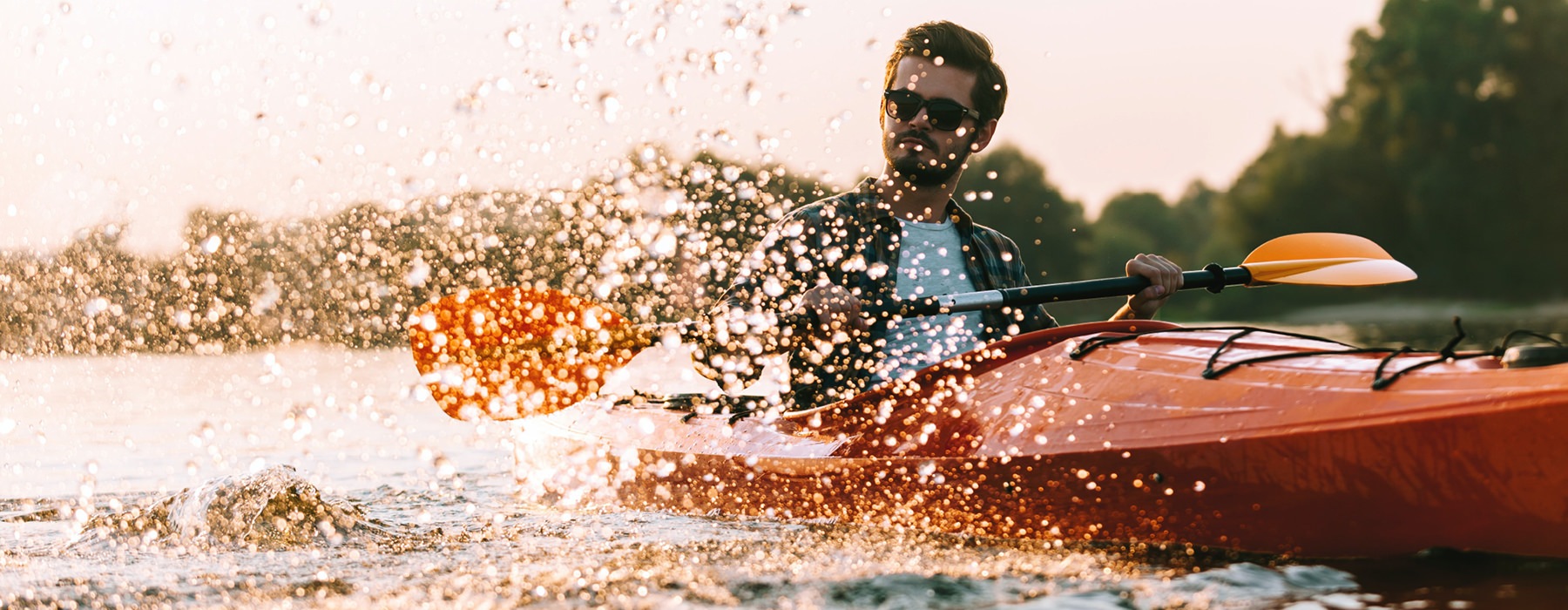 Young man kayaking in a lake